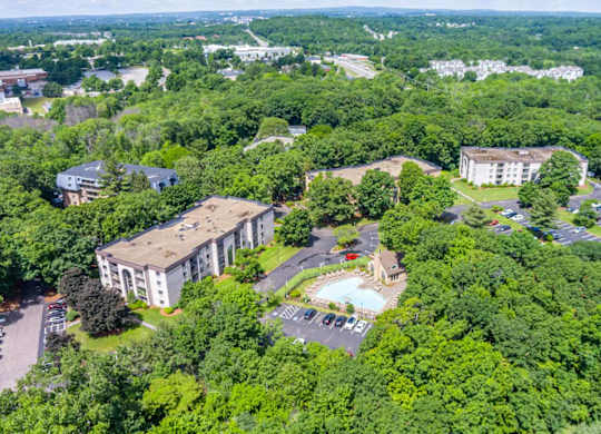 an aerial view of a campus with buildings and a swimming pool