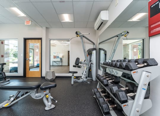 a gym with cardio equipment and weights at one mansfield ave
