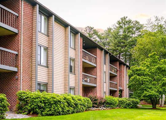 Stone run east apartment building exterior with lush landscaping