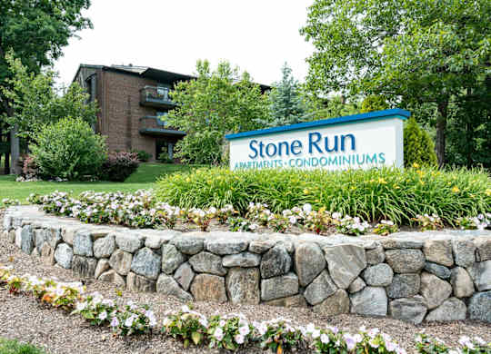 stone run entrance with flowers and plantings