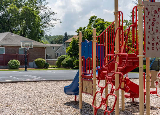 a playground with a basketball hoop in the background