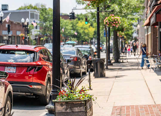 a city street with cars parked on the side of the road