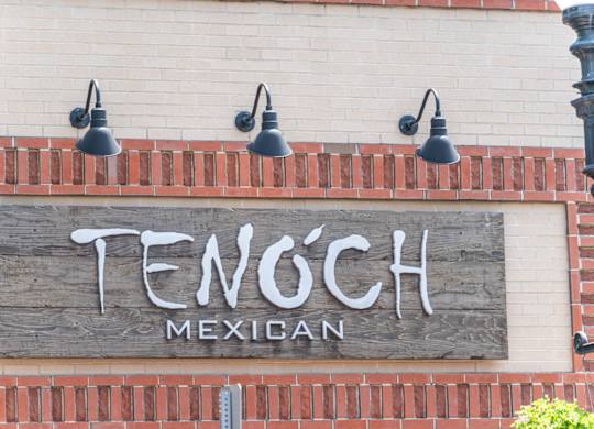 a sign on the side of a building "Tenoch Mexican"