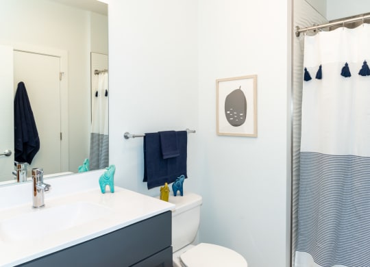 Model apartment bathroom with bright finishes