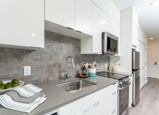 Union 346 Kitchen with bright white cabinets at Union 346, Somerville Massachusetts