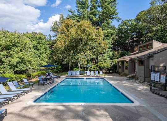 a swimming pool in the backyard of a house with a resort style pool