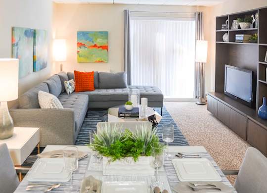 View of the living room and dining room at Weymouth commons with balcony doors