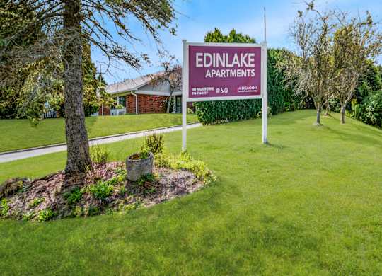 A sign for Edinlake Apartments is displayed in a grassy area.