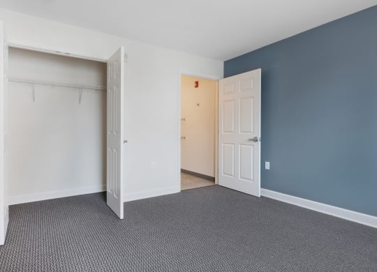 a bedroom with a closet and an open door at Waterfront Apartments, Buffalo, NY