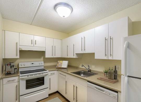 the preserve at ballantyne commons apartment kitchen with white cabinets and appliances at North Stoughton Village, Massachusetts, 02072