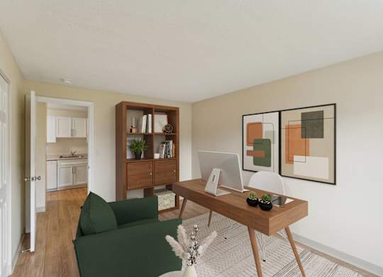 a living room with a desk with a computer and a green couch at North Stoughton Village, Massachusetts