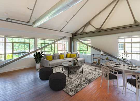 a living room with a couch and a table with chairsat Ames Shovel Works Apartments, Massachusetts, 02356