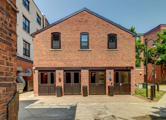 the front of a brick building with three doors at Ninth Square Apartments, New Haven, CT