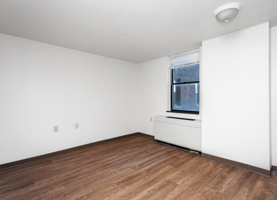 Bedroom of Apartment With Window and Woodlike Flooring.