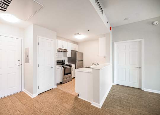 a renovated kitchen with white cabinets and stainless steel appliances at Ninth Square Apartments, Connecticut, 06510