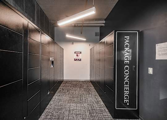 a hallway with black lockers and a welcome sign at Ninth Square Apartments, New Haven, CT, 06510