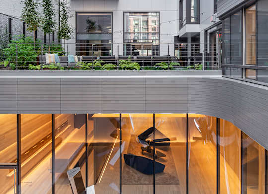 A modern building with a large metal sculpture in the lobby.