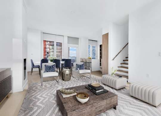 A modern living room with a wooden coffee table in the center.