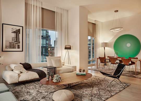 a living room with a green ball on the wall and a couch