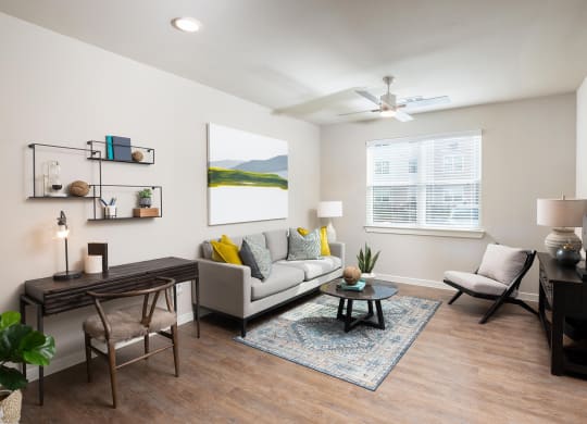 a living room with a ceiling fan and hardwood flooring at 55 Fifty at Northwest Crossing, Houston