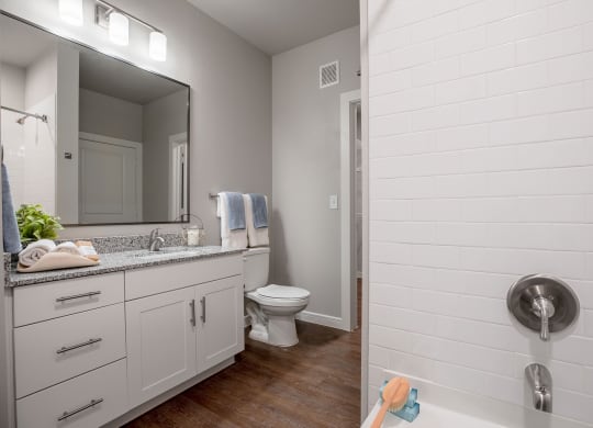a bathroom with a shower toilet and sink at 55 Fifty at Northwest Crossing, Houston, TX 77092