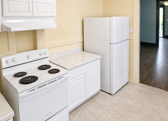 Kitchen with white stove and refrigerator at 4729 Roosevelt in Seattle