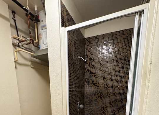 A bathroom with a toilet, sink and shower.