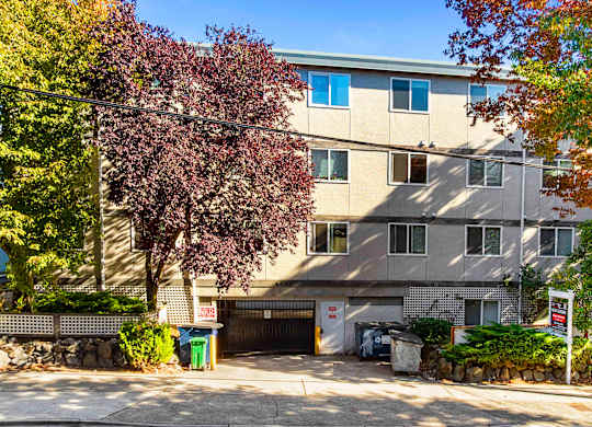 A building with a garage door and a sign that says
