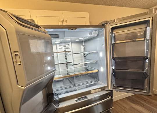 A stainless steel refrigerator in 2-bedroom apartment kitchen at Bridgeport Terrace Apartments.