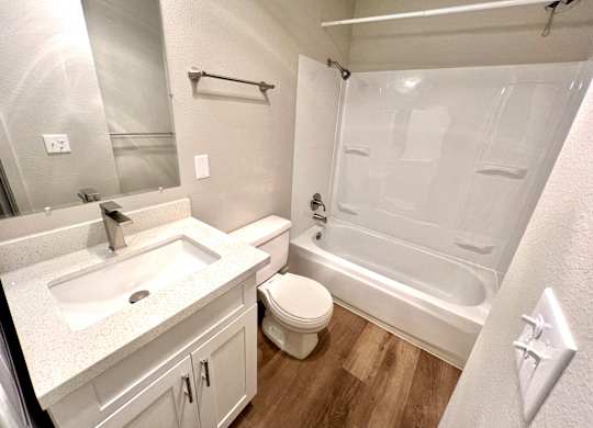 2-bedroom bathroom with a white & black washing machine and dryer and a shower & tub combination at Bridgeport Terrace Apartments