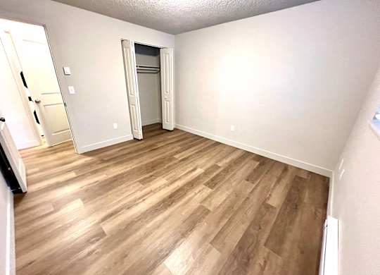 Bedroom 1 of 2 with vinyl plank flooring and a closet