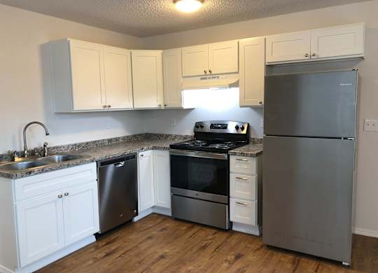 Bridgeport Terrace's Studio kitchen with white cabinets and stainless steel appliances.