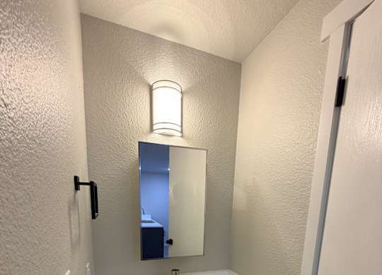 A bathroom with a sink and mirror.