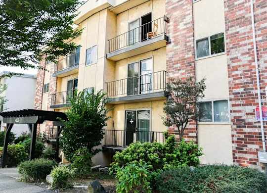 A building with a balcony and a black gate.