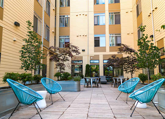 Bode125's community courtyard with  seating, tables, and foliage