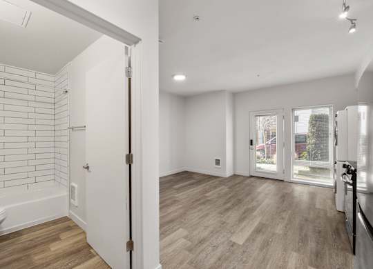 Studio apartment at Bode-88 with modern bathroom with white tile shower and luxury vinyl floor throughout