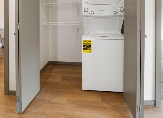 A white dishwasher is in a small kitchen space.