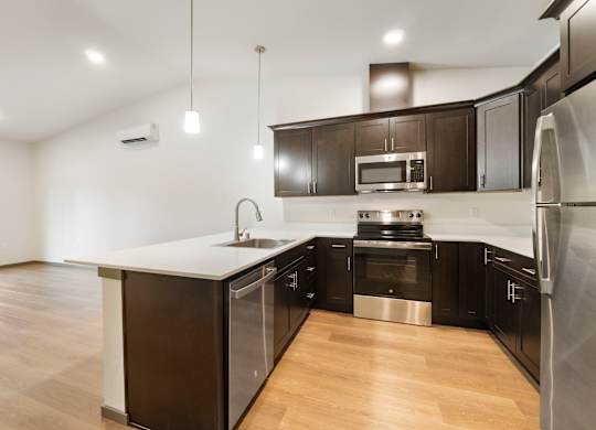 Modern kitchen with stainless steel appliances and hardwood floors