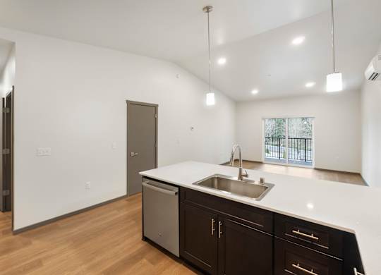 A kitchen with a sink and a refrigerator.