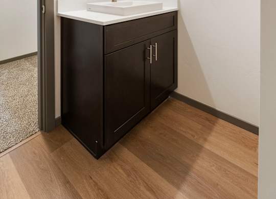 A bathroom with a sink and a mirror.