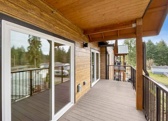 A wooden deck with a sliding glass door.
