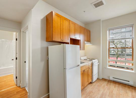 A kitchen with wooden cabinets and white appliances.