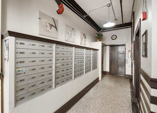 A hallway with mailboxes numbered from 201 to 214.