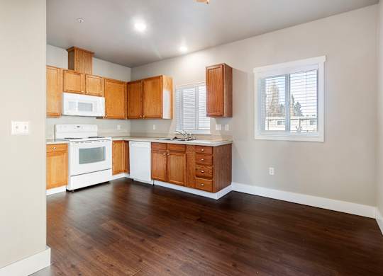 A kitchen with wooden cabinets and a white appliances
