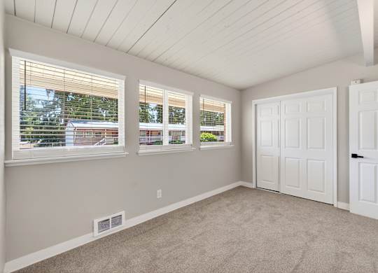 A room with white walls and a carpeted floor.