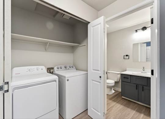 A small laundry room with a washer and dryer.