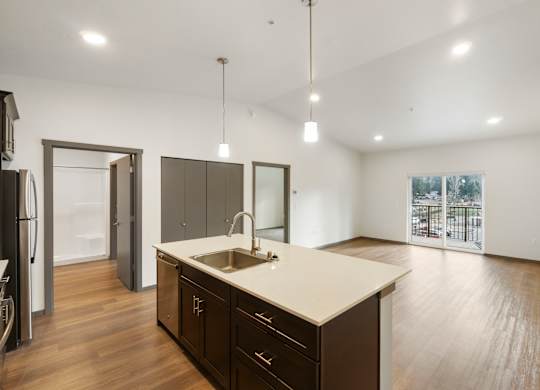 A kitchen with dark wood cabinets and a white countertop.