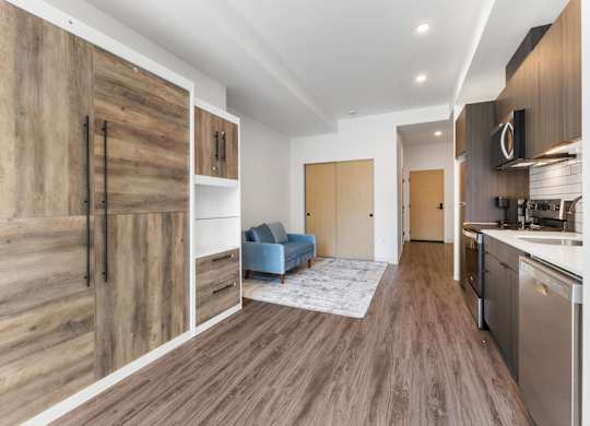 A modern kitchen with wooden floors and cabinets at The Hub Apartments, Lacey, Washington