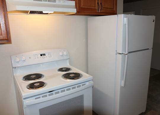 White refrigerator, stove and oven in 2-bedroom apartment home at Horizon Park Apartments