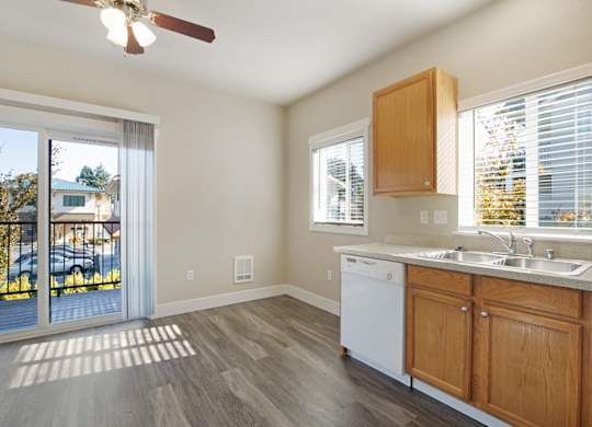 Kitchen with oak cabinets and light color countertops and wood plank vinyl flooring at Hearthstone Apartments
